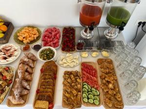 a table with many different types of food and drinks at Otto Hotel in Ksamil