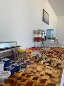 a table full of different types of pastries and desserts at Otto Hotel in Ksamil