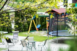 a playground with chairs and a trampoline at Apartamenty przy Pensjonacie Zdrojowym in Rabka-Zdrój