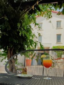 a glass of orange juice sitting on a table at Logis Hotel Le Nouvel in Portes-lès-Valence