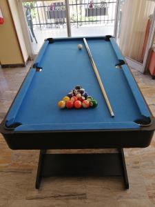 a pool table with two cuesticks and balls on it at Hotel Luca in Rimini