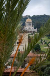 a building with a dome on top of it at Via Maria Boutique Suites In The Middle Of The city in Haifa