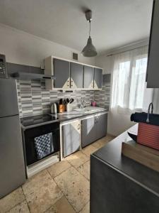 a kitchen with stainless steel appliances in a kitchen at L'Escala Arles Centre in Arles