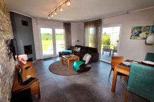 a living room with a couch and a table at Villa Anima in Göhren-Lebbin