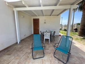 a patio with two chairs and a table at Case vacanze Spagnola 106 in Marsala