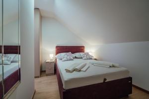 a bedroom with a bed with two shoes on it at Apartman Josipa in Zagvozd