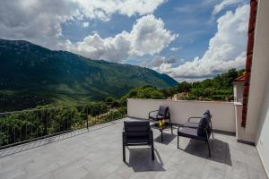 a balcony with chairs and a view of mountains at Apartman Josipa in Zagvozd