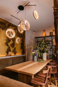 a wooden table in a room with chairs and lights at Hotel Marignan Champs-Elys&eacute;es in Paris