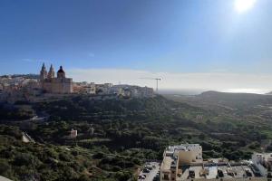 an aerial view of a city on a hill at Luxury Seaview Mellieha Apartment in Mellieħa