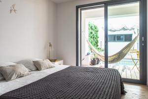 a bedroom with a bed and a large window at Avignon centre, Maison avec Piscine in Avignon