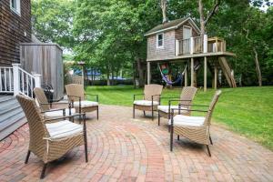 a patio with chairs and a table and a playground at 28 Ocean Pkwy, East Hampton NY 11937 in East Hampton