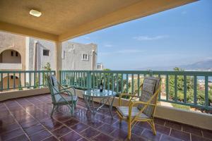 a patio with a table and chairs on a balcony at Primavera Suite in Stalida +9 photos