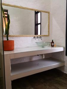 a bathroom with a sink and a mirror at Hotel Mulato in El Colegio
