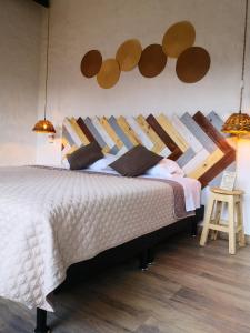 a bedroom with a large bed with wooden headboard at Hotel Mulato in El Colegio