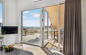 uma sala de estar com uma grande janela com vista para o oceano em Kysthusene em Engvang