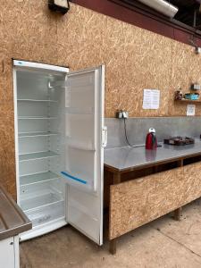 an open refrigerator in a kitchen with a counter at Autokemp Loděnice Zdoňov - Adršpach in Teplice nad Metují