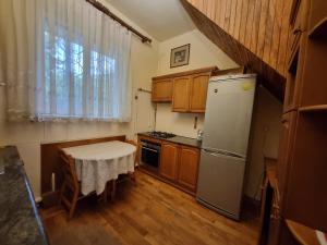 a kitchen with a refrigerator and a table in it at Star Apartment in Ashtarak, Mughni in Ashtarak