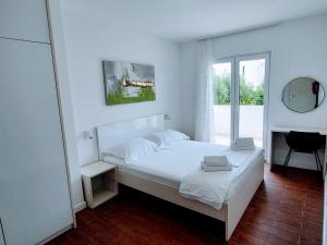 a white bedroom with a bed and a window at Villa Ana Sevid in Sevid +39 photos