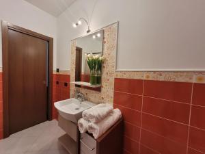 a bathroom with a sink and a mirror at A Rimirar il Lago Mountain Lake Iseo Hospitality in Bossico