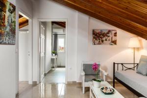 a living room with a couch and a table at Attico Verde in Kastanéa +7 photos