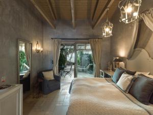 a bedroom with a king sized bed and a patio at Six Keys in Afissos