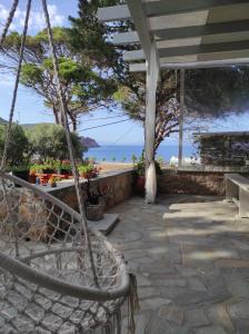 a porch with a view of the beach at Lampi's House in Patmos
