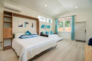 a bedroom with two beds with blue pillows at Urban-chic Studio Guesthouse in a quiet neighborhood - near Intel and Nike in Hillsboro