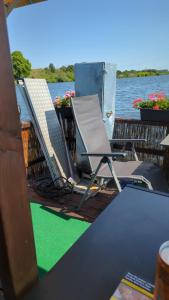 a group of chairs sitting on the deck of a boat at Hausboot Pretty Belinda in Wessem