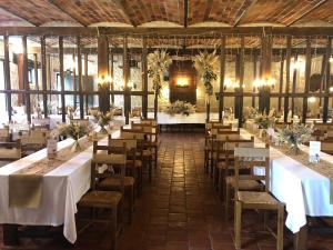 a large room with tables and chairs in it at Maison des mariés in Beaulieu-sur-Loire