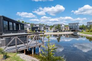 a bridge over a body of water with buildings at SMILGA & KOPA home - Mano jūra 2 Kunigiškiai - by Hello Sea homes in Palanga