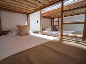 two beds in a room with two bunk beds at Casa García Rent Home in Guatapé