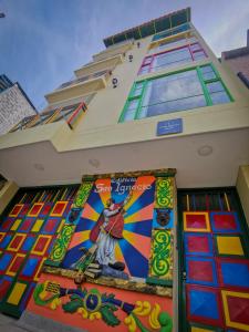 a building with a mural on the side of it at Casa García Rent Home in Guatapé