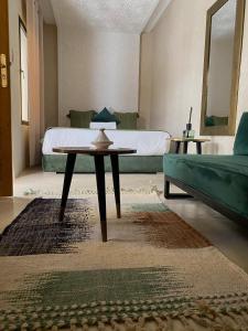 sala de estar con cama, mesa y sofá en Riad Olika, en Marrakech