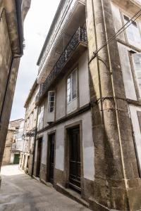 ein altes Gebäude an der Straßenseite in der Unterkunft Hostal San Pelayo in Santiago de Compostela