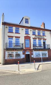 a large brick building on the side of a street at LONDONDERRYS Bar and Accommodation in Seaham