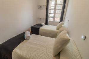 Posteľ alebo postele v izbe v ubytovaní Hostal San Pelayo
