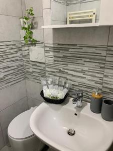 a bathroom with a white sink and a toilet at LA FARFALLA in Rome