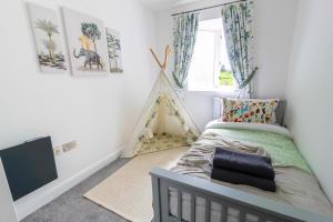 a bedroom with a bed and a play tent at Luxury Apartments - MBS Lettings in Bewdley