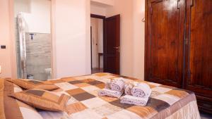 ein Schlafzimmer mit einem Bett mit Handtüchern darauf in der Unterkunft PM 12 Via Achille Grandi Guest House in Alghero