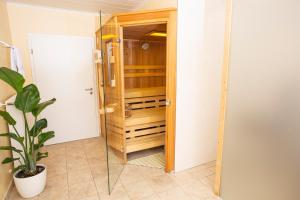 a bathroom with a wooden closet with a potted plant at Ferienwohnung in Lippstadt +9 photos