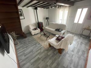 an aerial view of a living room with a couch and chairs at Les Demoiselles du Lac in Braucourt