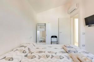 a bedroom with a bed with towels on it at Casa SarTuga in SantʼAntìoco