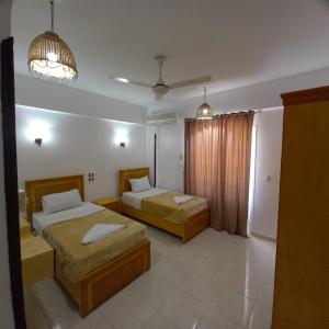 A bed or beds in a room at Nile Sunrise Flats
