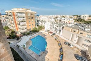 arial view of a swimming pool in a city at Pool Apartment-Hosted by Sweetstay in Is-Swieqi