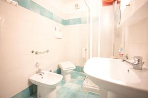 a white bathroom with a sink and a toilet at Casa Pamalù in Nisporto +18 photos