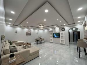 a living room with a couch and a table at Beitk Al-ula Apartments شقق بيتك العلا in AlUla