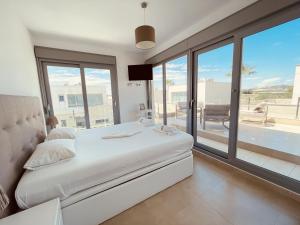 a bedroom with a white bed and a large window at 3091 Villa MALIBU in Orihuela +34 photos