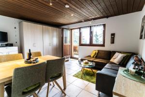a living room with a table and a couch at Haus Sportina in Riederalp