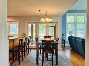 a dining room and kitchen with a table and chairs at Fairway to Heaven home in Supply