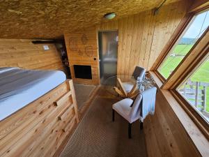 a bedroom with a bed and a table and a chair at LOGIS LAS CROZAS La Poupe in Vernines